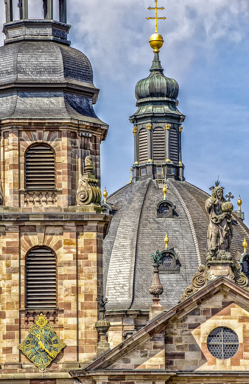 Historic Sandstone Church Facade With Golden Cross And Dome