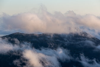 Misty Mountain Peak Through Clouds at Dusk
