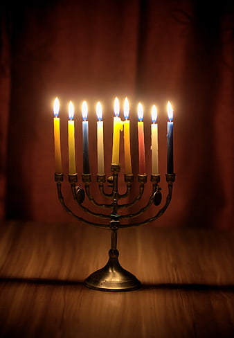 Lit Menorah with Colorful Candles on Wooden Table
