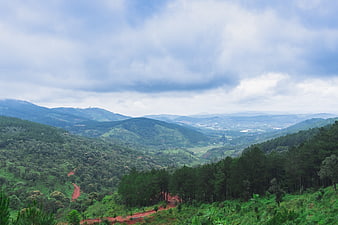 Lush Green Mountain Valley Landscape With Dramatic Clouds