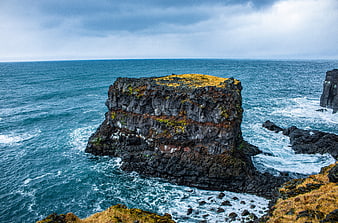 Dramatic Volcanic Sea Stack in Turquoise Ocean Waters