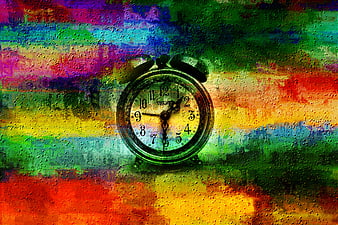 Vintage alarm clock on colorful abstract textured background
