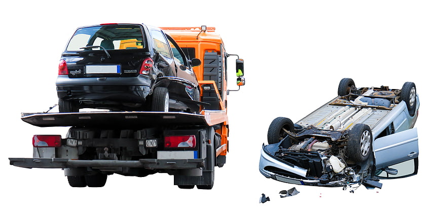 Tow truck carrying damaged car and overturned wreck isolated