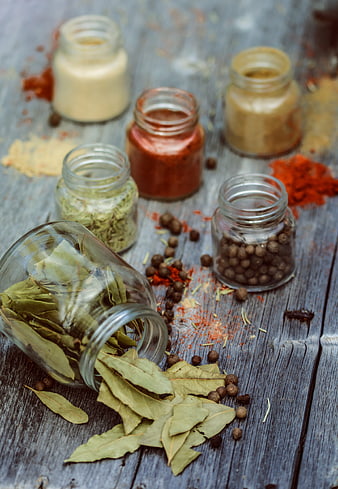Assorted Spices in Glass Jars on Rustic Wooden Table