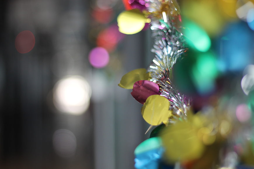 Close-up of colorful party tinsel and confetti with bokeh background