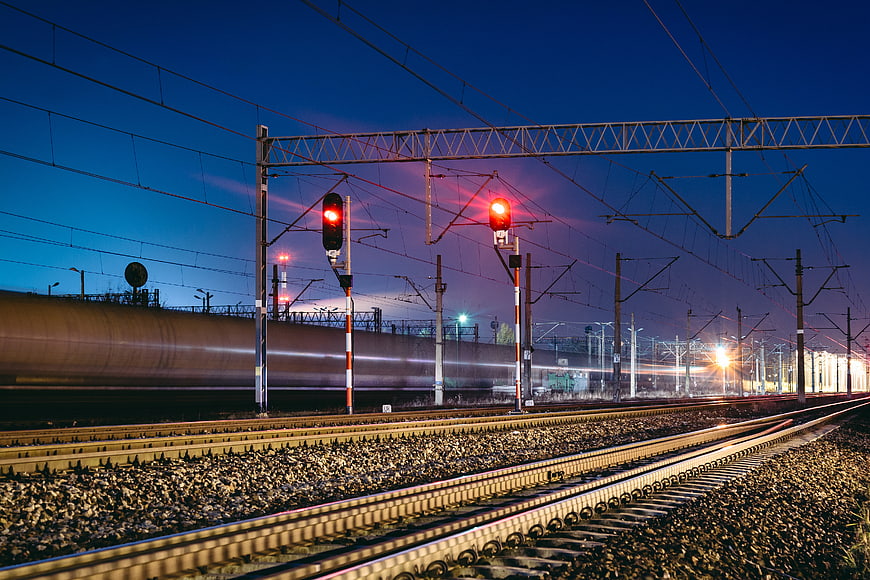 High-speed train motion blur on railway tracks at dusk