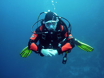 Scuba Diver Underwater in Blue Ocean with Bubbles