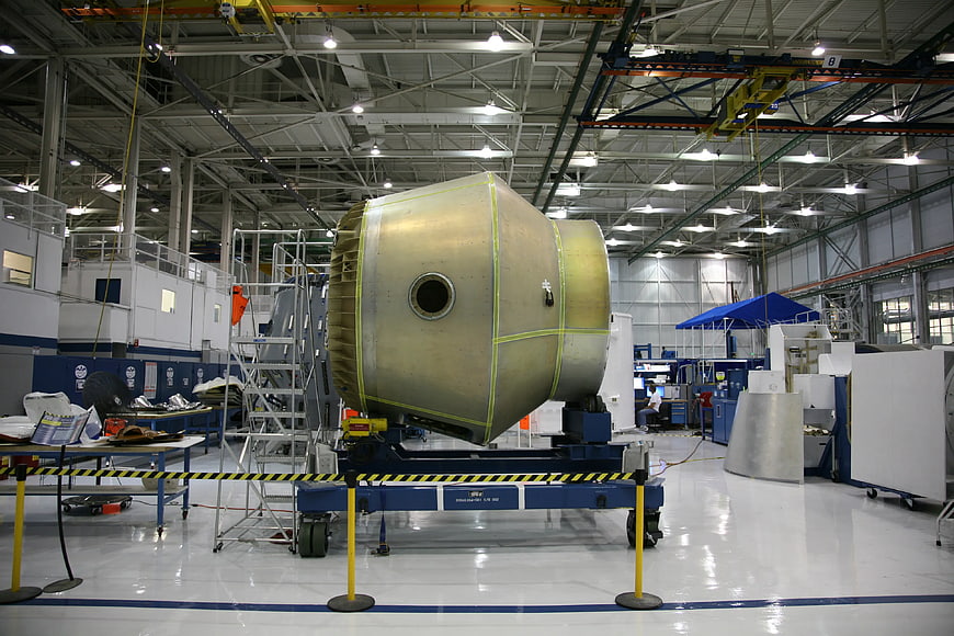 Large rocket engine assembly in aerospace manufacturing facility