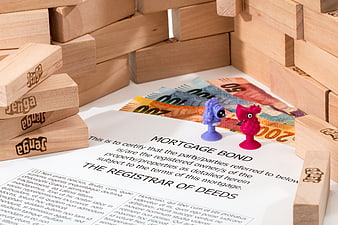 Mortgage Bond Document with Jenga Blocks and Euro Banknotes