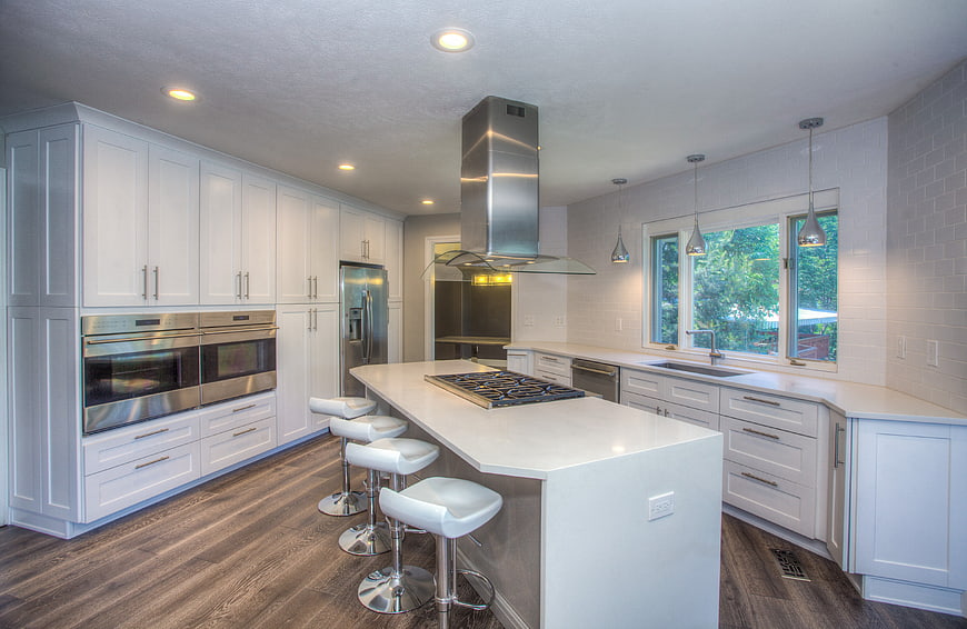 Modern white kitchen with island and stainless steel appliances