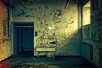 Abandoned dilapidated room with peeling walls and sink