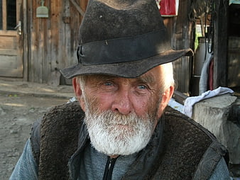 Portrait of elderly man with white beard and black hat
