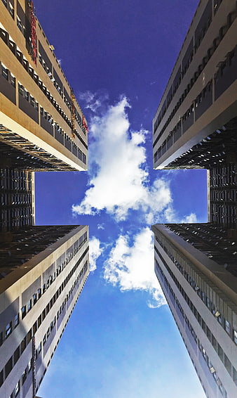 Low Angle View of Four Skyscrapers Framing Blue Sky