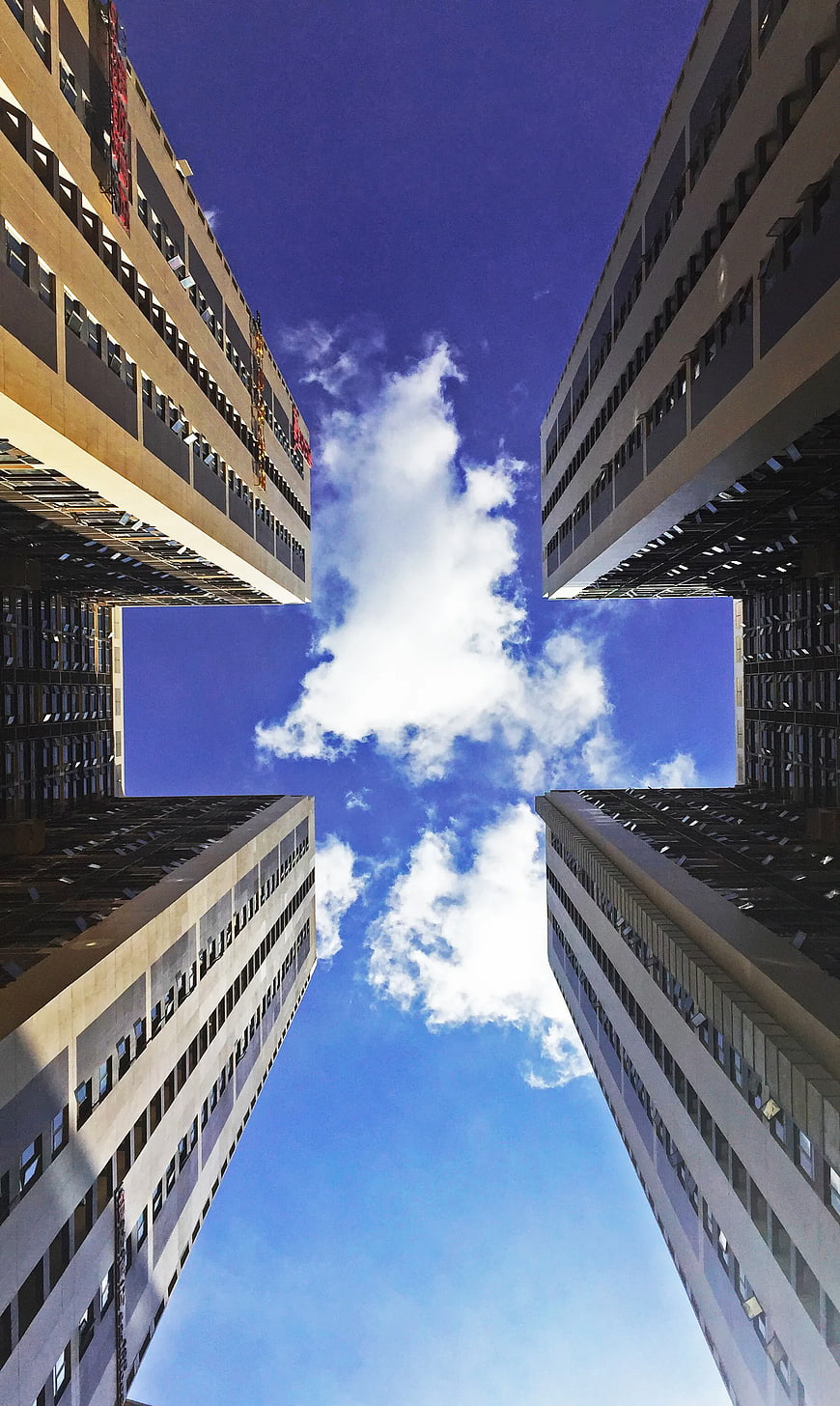 Low Angle View of Four Skyscrapers Framing Blue Sky