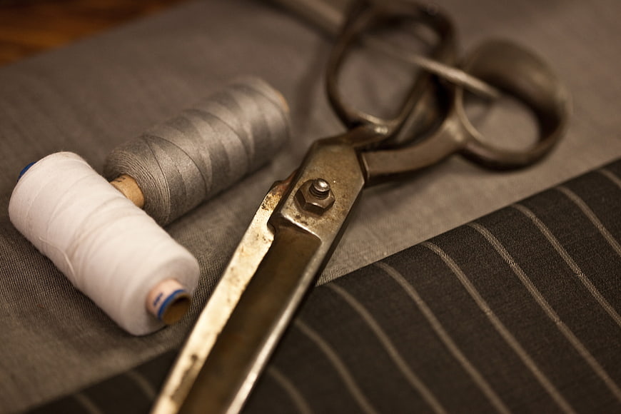 Vintage Tailoring Scissors and Thread Spools on Fabric