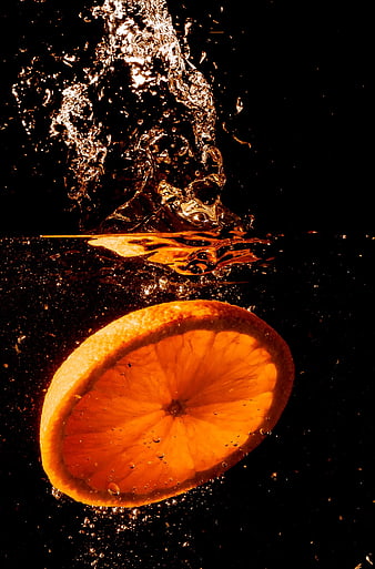 Sliced Orange Submerged in Water with Splash