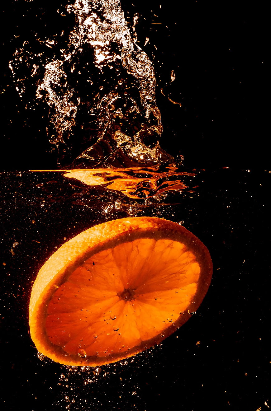 Sliced Orange Submerged in Water with Splash