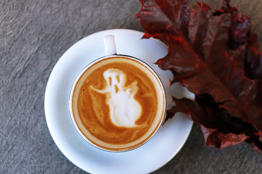 Halloween Ghost Latte Art in White Cup with Red Leaf