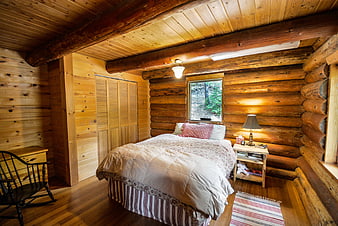 Rustic Log Cabin Bedroom Interior With Wooden Walls And Cozy Bed