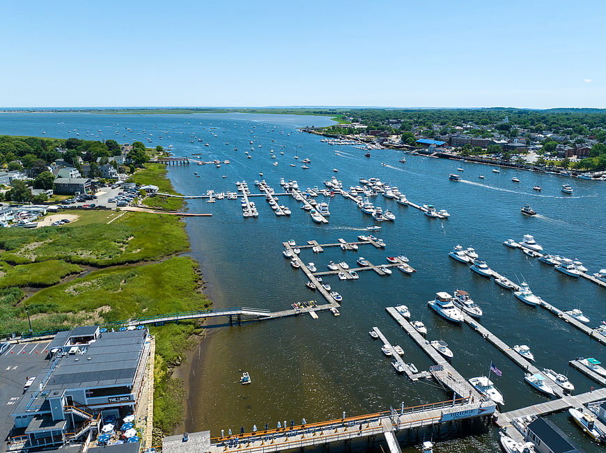Aerial View of Busy Coastal Harbor with Boats and Marina
