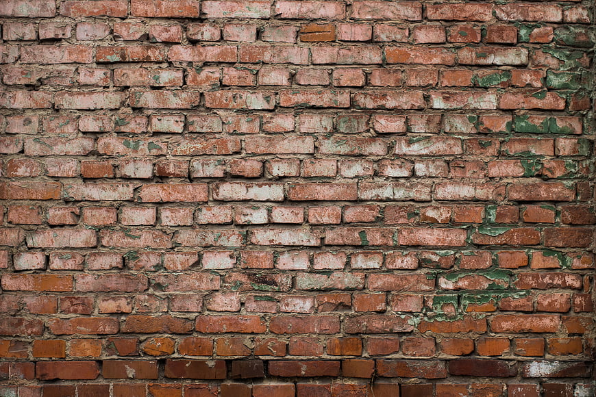 Weathered Red Brick Wall Texture with Peeling Green Paint