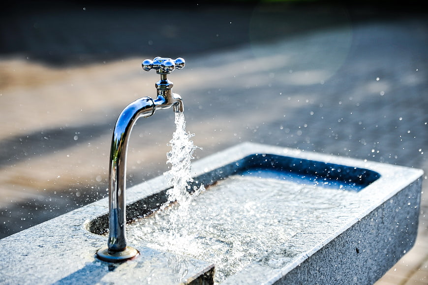 Close-up of water flowing from a chrome outdoor tap