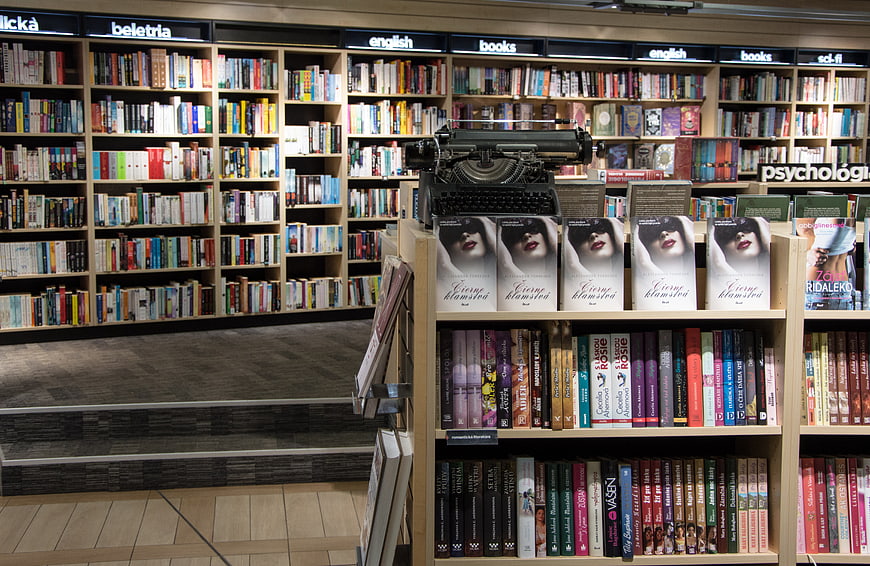 Vintage Typewriter Displayed On Bookstore Shelf With Literature