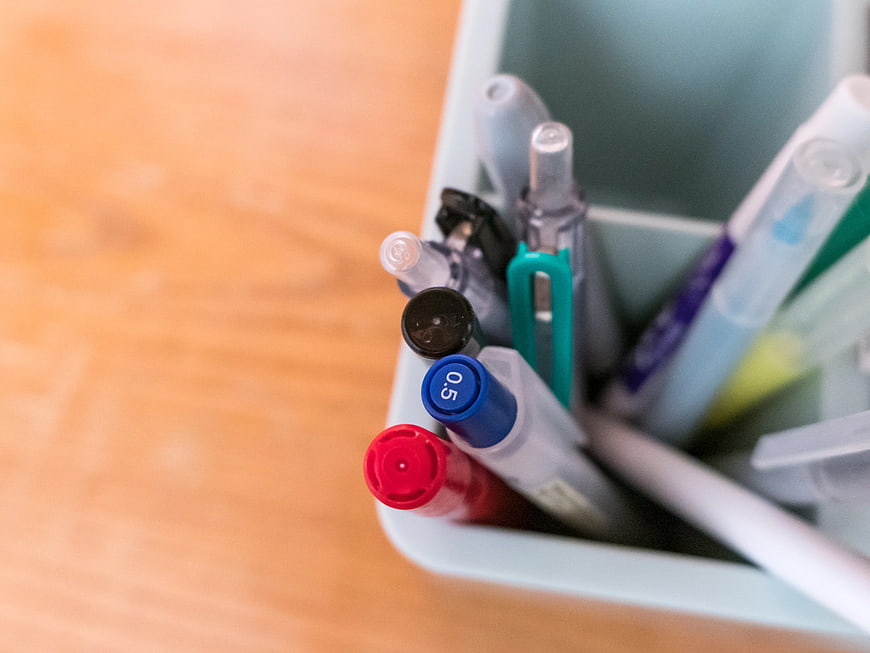 Close-up of colorful pens in a desk organizer