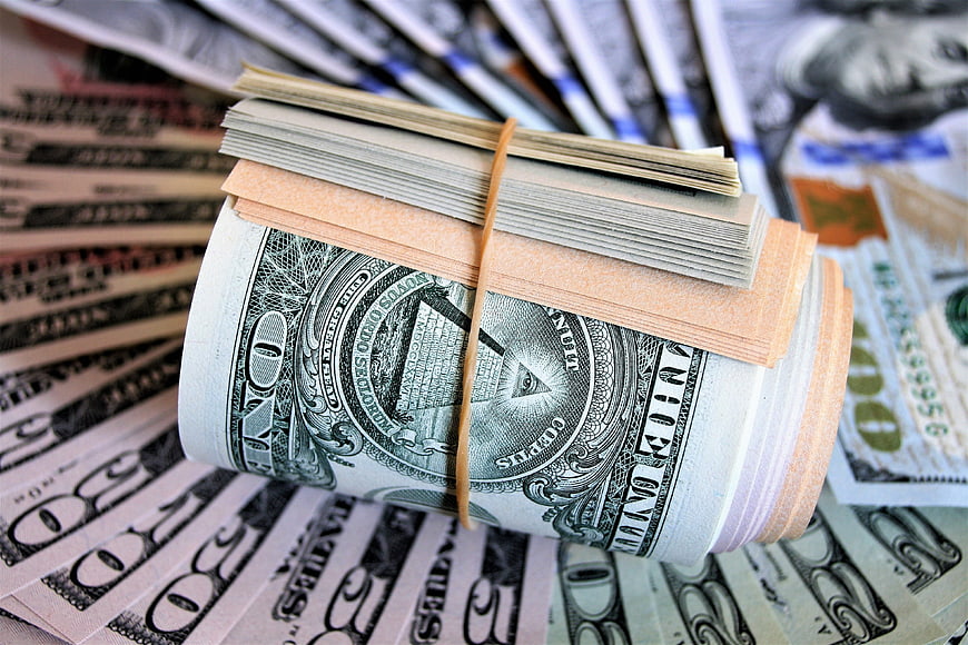 Stack of US Dollar Bills and Cash on Background of Money