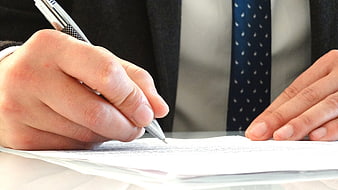 Close-up of Businessman Signing Legal Documents