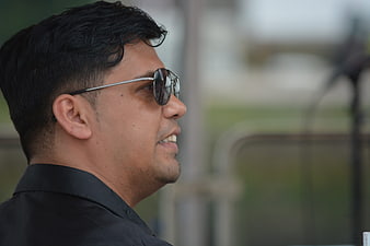Profile of man in sunglasses outdoors