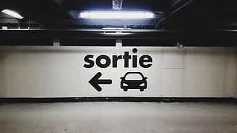 French parking exit sign with car icon and arrow