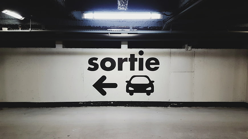 French parking exit sign with car icon and arrow