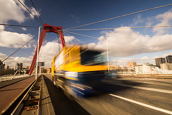 Motion Blur Yellow Truck on Red Arch Bridge