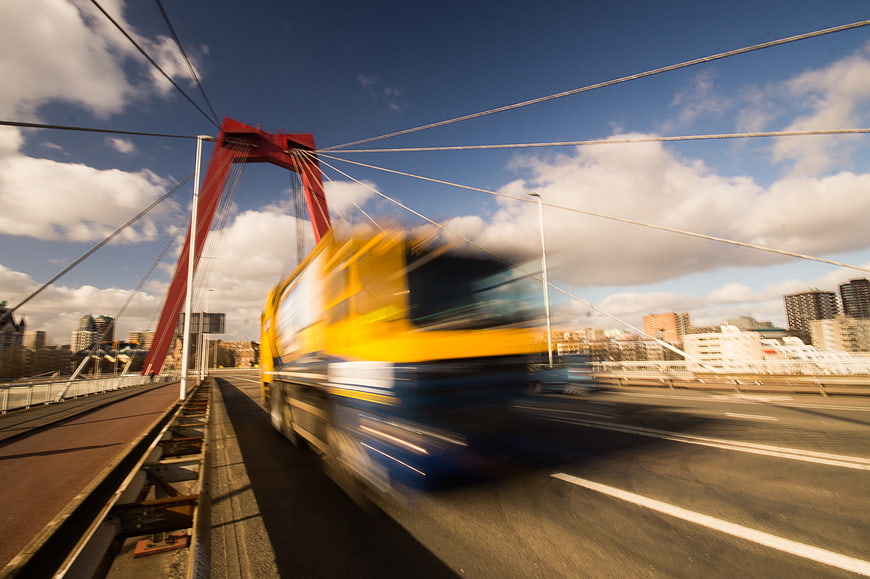 Motion Blur Yellow Truck on Red Arch Bridge