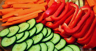 Sliced Carrots, Red Bell Peppers, and Cucumbers on Wooden Board