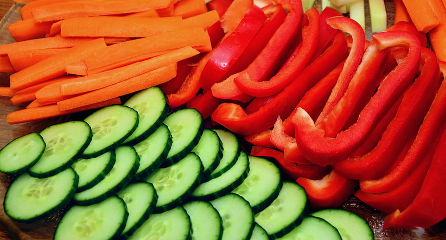 Sliced Carrots, Red Bell Peppers, and Cucumbers on Wooden Board