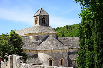 Ancient stone abbey with slate roof and bell tower