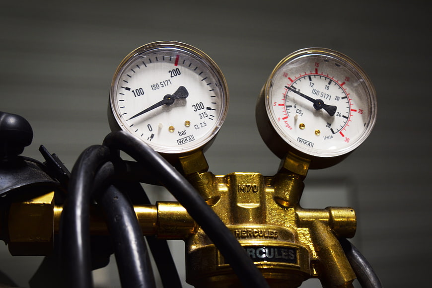 Close-up of brass gas regulator with pressure and flow meters