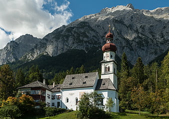 White Church with Onion Dome in Alpine Landscape