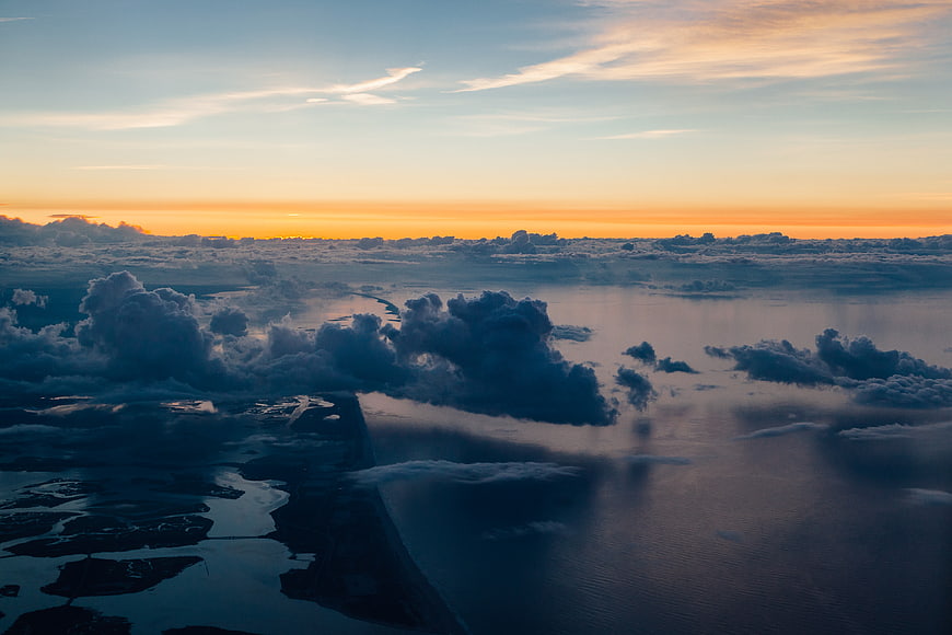 Aerial View of Coastal Landscape at Sunset with Clouds