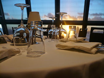 Upscale Restaurant Table Setting With Wine Glasses And Sunset View