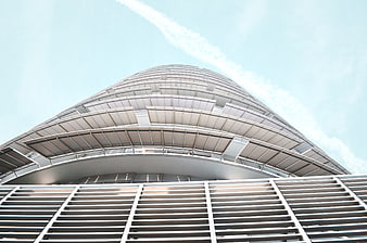 Low angle view of modern curved skyscraper facade