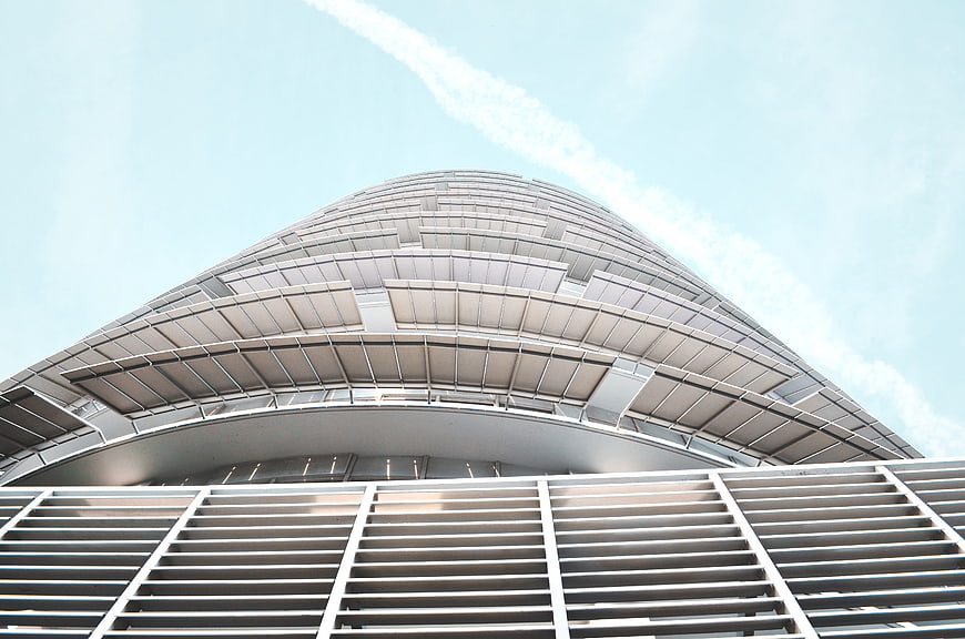 Low angle view of modern curved skyscraper facade