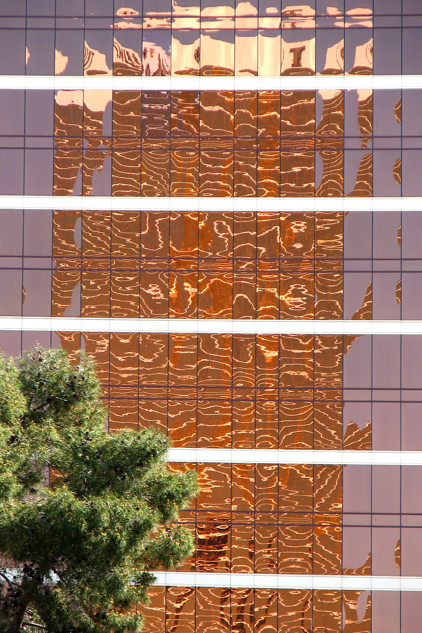 Abstract Reflection of Golden Skyscraper on Glass Facade