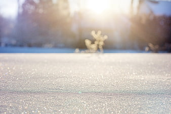 Sparkling Snow Texture with Sunlight and Bokeh Background