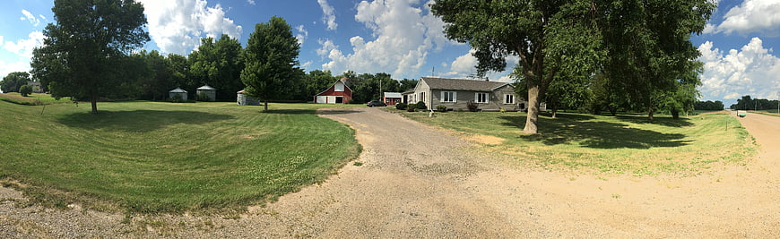 Panoramic View of Rural Farmhouse and Red Barn
