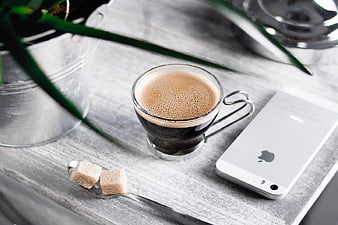 Black Coffee, Smartphone, and Sugar Cubes on Wooden Desk