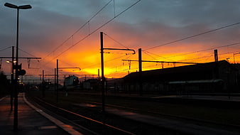 Silhouette of Train Tracks at Vibrant Sunset