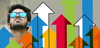 Man with sunglasses looking up at colorful growth arrows